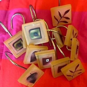 12 Shower curtain hooks. Resin . Green /maroon leaf pattern